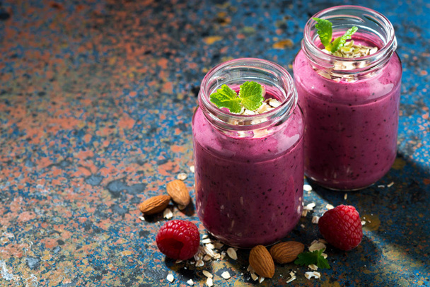 healthy berry smoothie in a bottle on a dark background - Фото, изображение