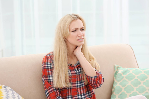 Young woman with allergy sitting on sofa at home - Photo, Image