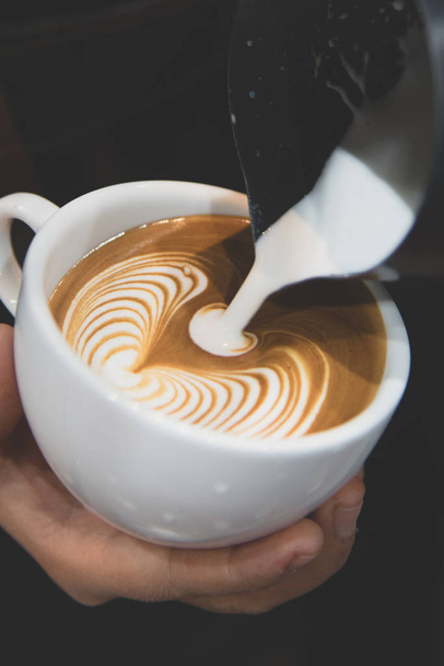 Barista έκχυση latte αφρό κάνει καφέ latte art - Φωτογραφία, εικόνα