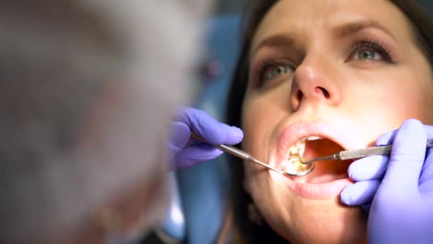 Closeup woman getting a dental treatment - Кадри, відео