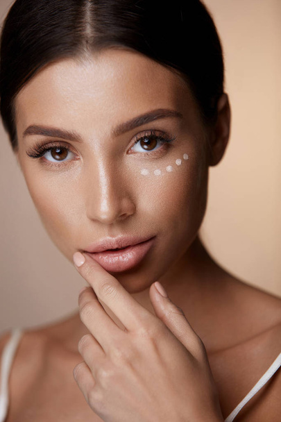 Beauty Woman Face With Makeup And Corrector Under Eyes - Valokuva, kuva