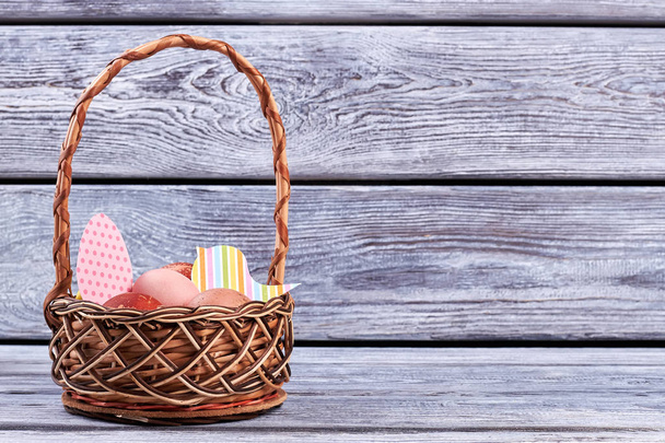 Easter basket, gray wood background. - Photo, Image