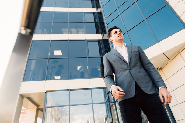 Young attractive business man outdoors in front of office building - Photo, image