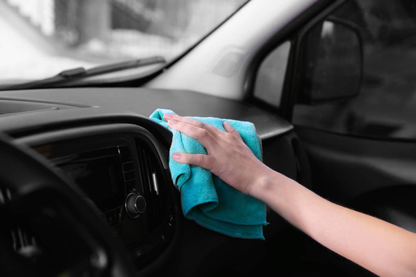 Female hand cleaning dashboard in car - Foto, Imagen