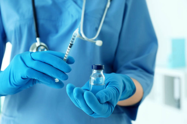 Doctor in gloves with syringe  - Фото, зображення