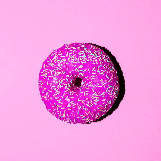 Donut on a pink background. Minimal. Surreal fashion art - Photo, image