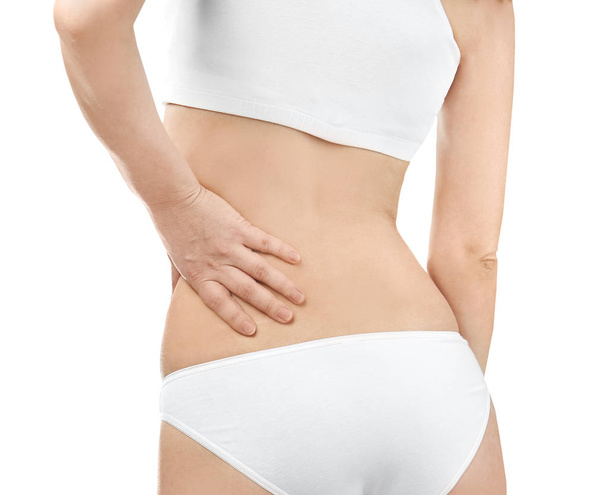 Young woman suffering from back pain on white background, closeup - Foto, Imagem