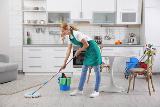 Woman with mop cleaning home - 写真・画像