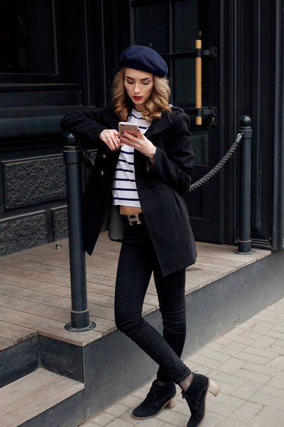 Street photo of young beautiful woman wearing stylish classic clothes. - Fotó, kép