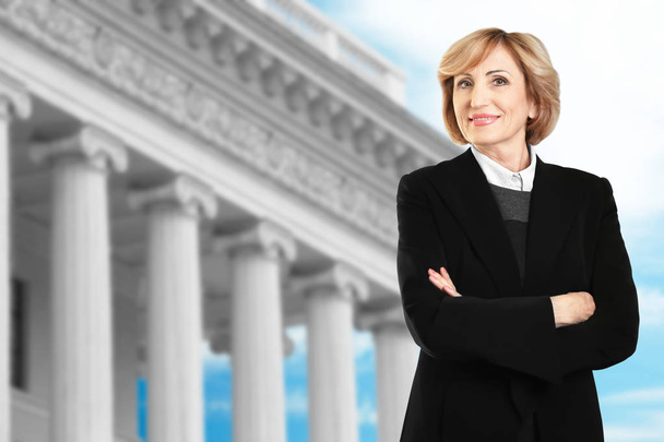 Law and justice concept. Senior woman on courthouse background - Φωτογραφία, εικόνα