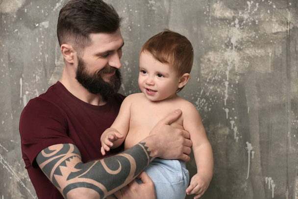 young man holding little boy - Fotografie, Obrázek
