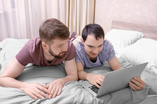 Gay couple lying on bed   - Foto, Imagem