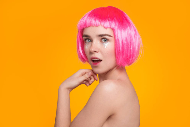Lovely girl in pink wig posing - 写真・画像
