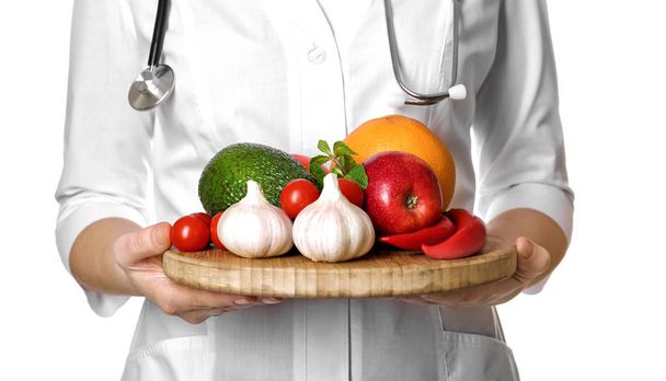 Doctor holding board with healthy food - Foto, Bild