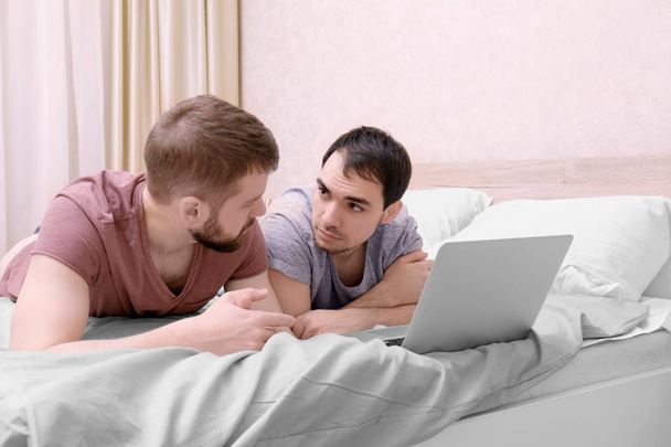 Gay couple lying on bed   - Foto, Imagen
