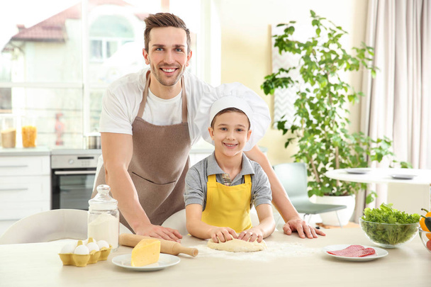 Dad and son cooking at home - Foto, Bild