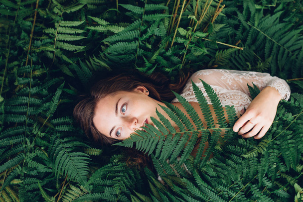 Red-haired girl with fern - Foto, immagini