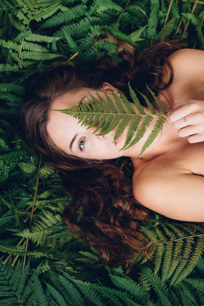 Red-haired girl with fern - Photo, Image