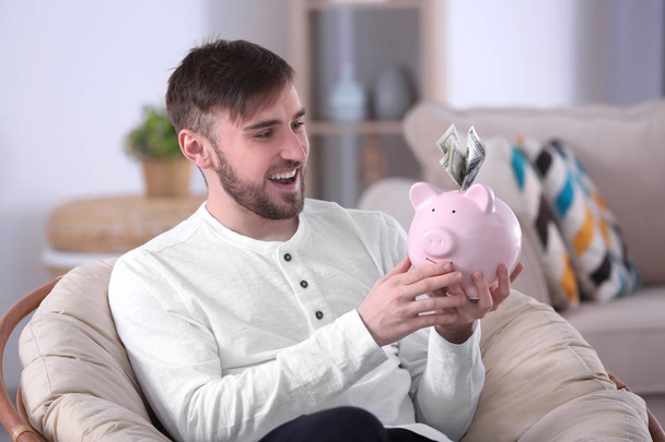 Happy young man with piggy bank  - Photo, image