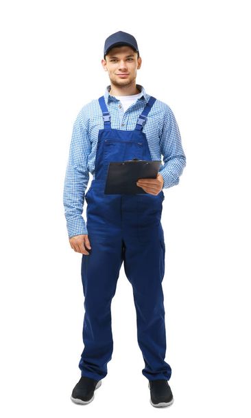 Young plumber in uniform holding clipboard - Фото, зображення