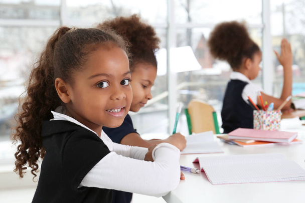 Cute African-American girls in classroom - Foto, Bild