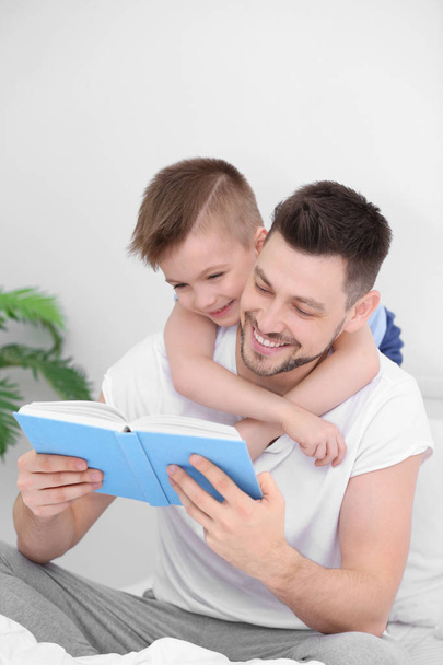 Dad and son reading interesting book   - Photo, image