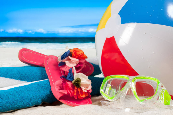 Summer vacation. Mask goggles and color ball on beach background - Foto, Imagem