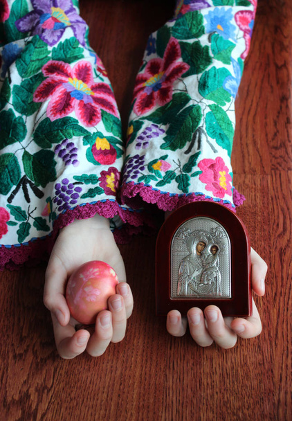 Ukraiński dziewczyna trzyma ikonę Matki Bożej i jaja wielkanocne - Zdjęcie, obraz