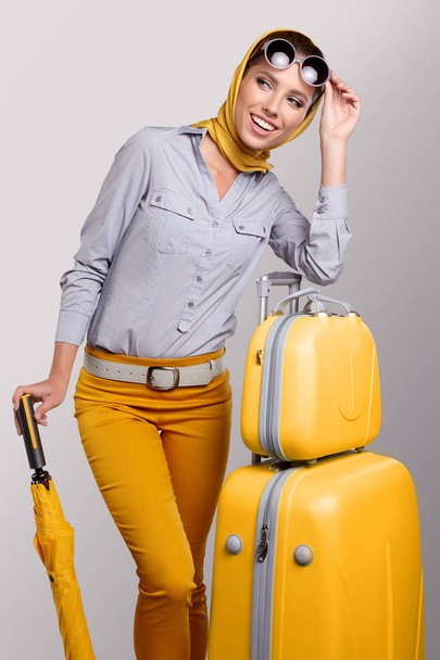 Glamour woman with yellow suitcase - 写真・画像