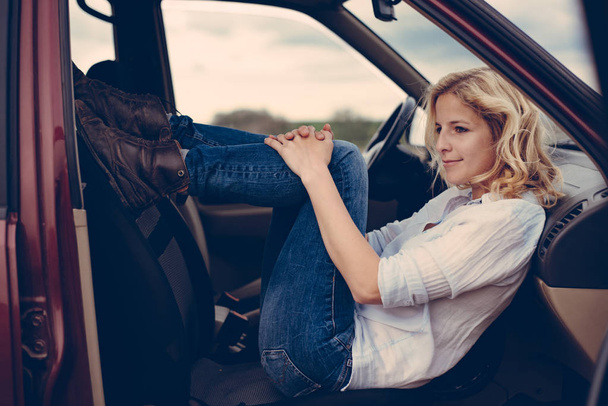 Cute, young woman in off road vehicle during road trip. Lifestyle concept. - Fotó, kép