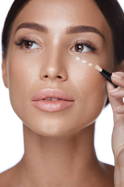 Beauty Woman Face Makeup. Female Applying Corrector Under Eyes - Fotó, kép