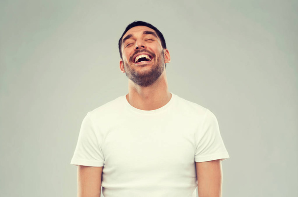 laughing man over gray background - 写真・画像