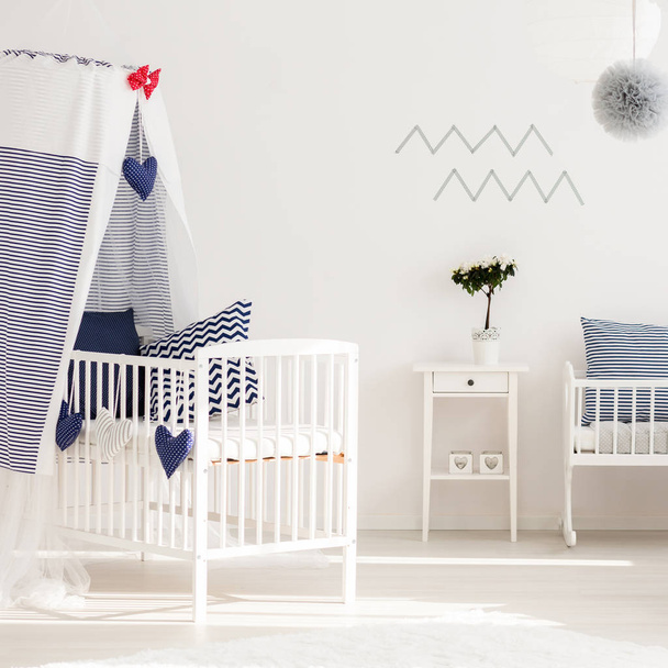 Lovely infant bedroom with simple furniture - Фото, изображение
