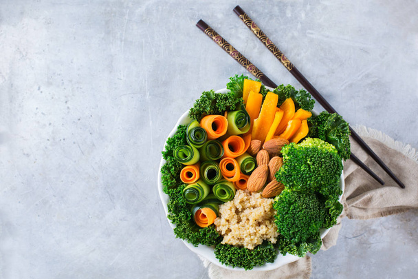 Healthy vegan buddha bowl with kale leaves and raw vegetables - Photo, Image