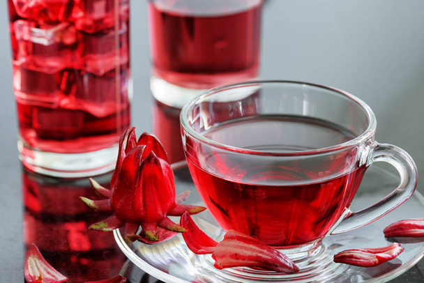 Cup of hibiscus tea (rosella, karkade) on table - Фото, зображення