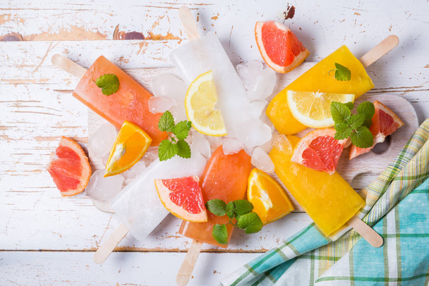 Colorful popsicles on rustic wood background - Foto, imagen