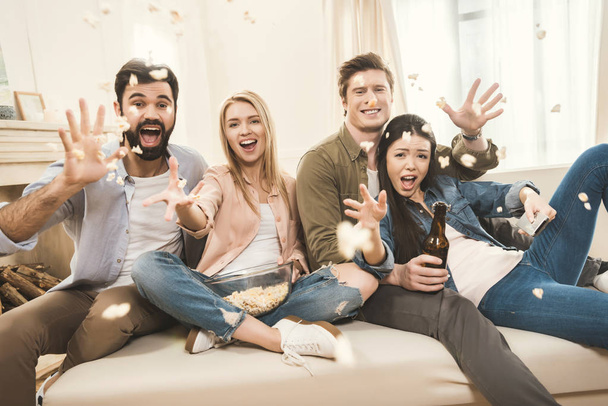 people on couch throwing popcorn upside - Photo, image