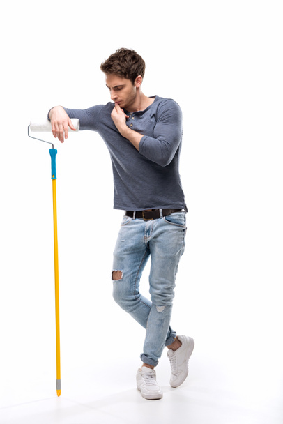 Hombre sosteniendo rodillo de pintura
 - Foto, imagen