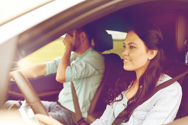 woman driving car and man covering face with palm - Foto, Imagen