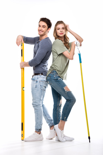 couple with paint roller and level - Foto, imagen