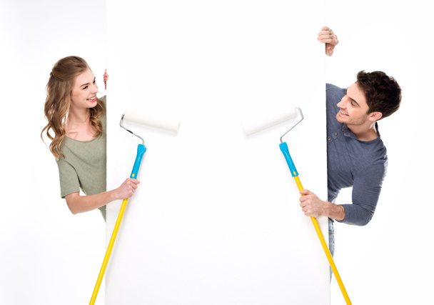 couple holding paint rollers - 写真・画像
