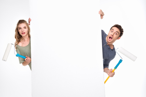 Couple with paint rollers and card  - Foto, imagen
