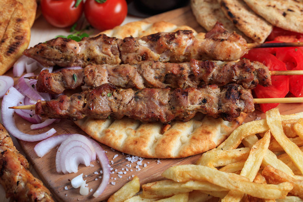 Grilled meat skewers on a pita bread - Photo, Image