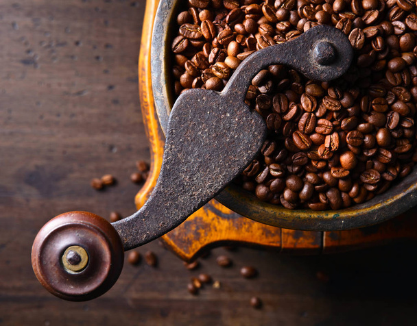  Roasted coffee beans in old coffee grinder.  - Photo, Image