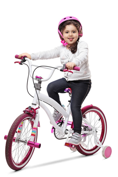 girl on a bike sticking her tongue out - Photo, image