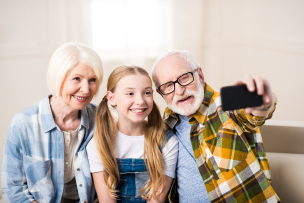 Girl with grandparents taking selfie - Φωτογραφία, εικόνα