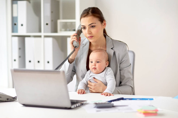 businesswoman with baby calling on phone at office - Photo, Image