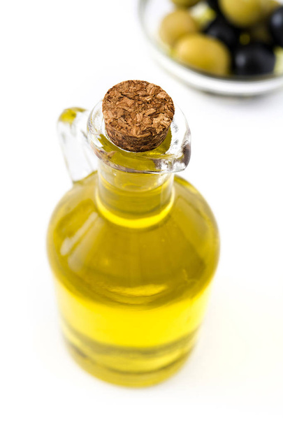 Virgin olive oil in a crystal bottle isolated on white background - Fotografie, Obrázek