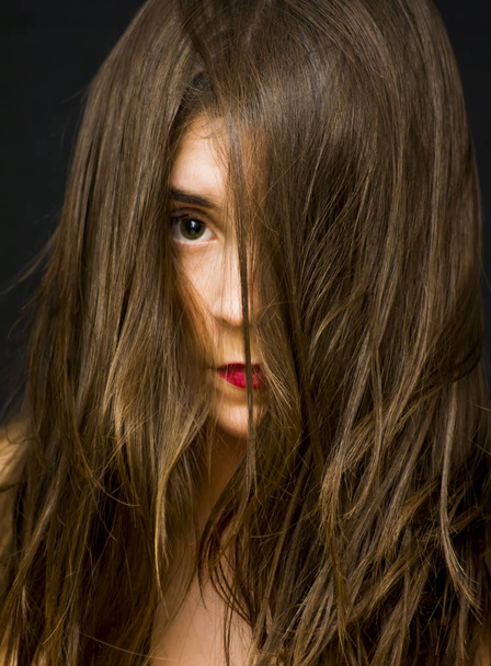 Portrait of a beautiful woman  with her hair fallen on her face - Fotografie, Obrázek