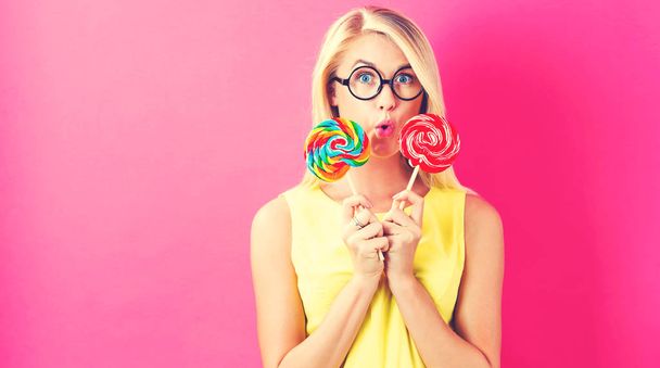 Young woman holding lollipops - Photo, Image